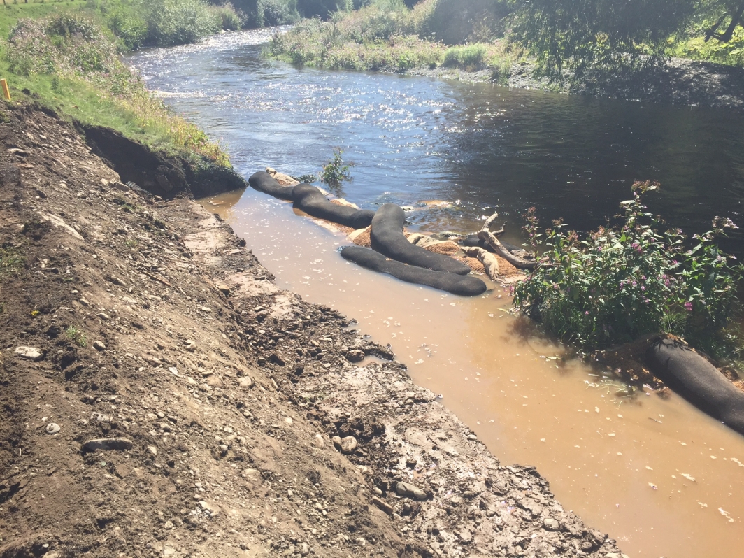 Silt wattles holding back silted up water